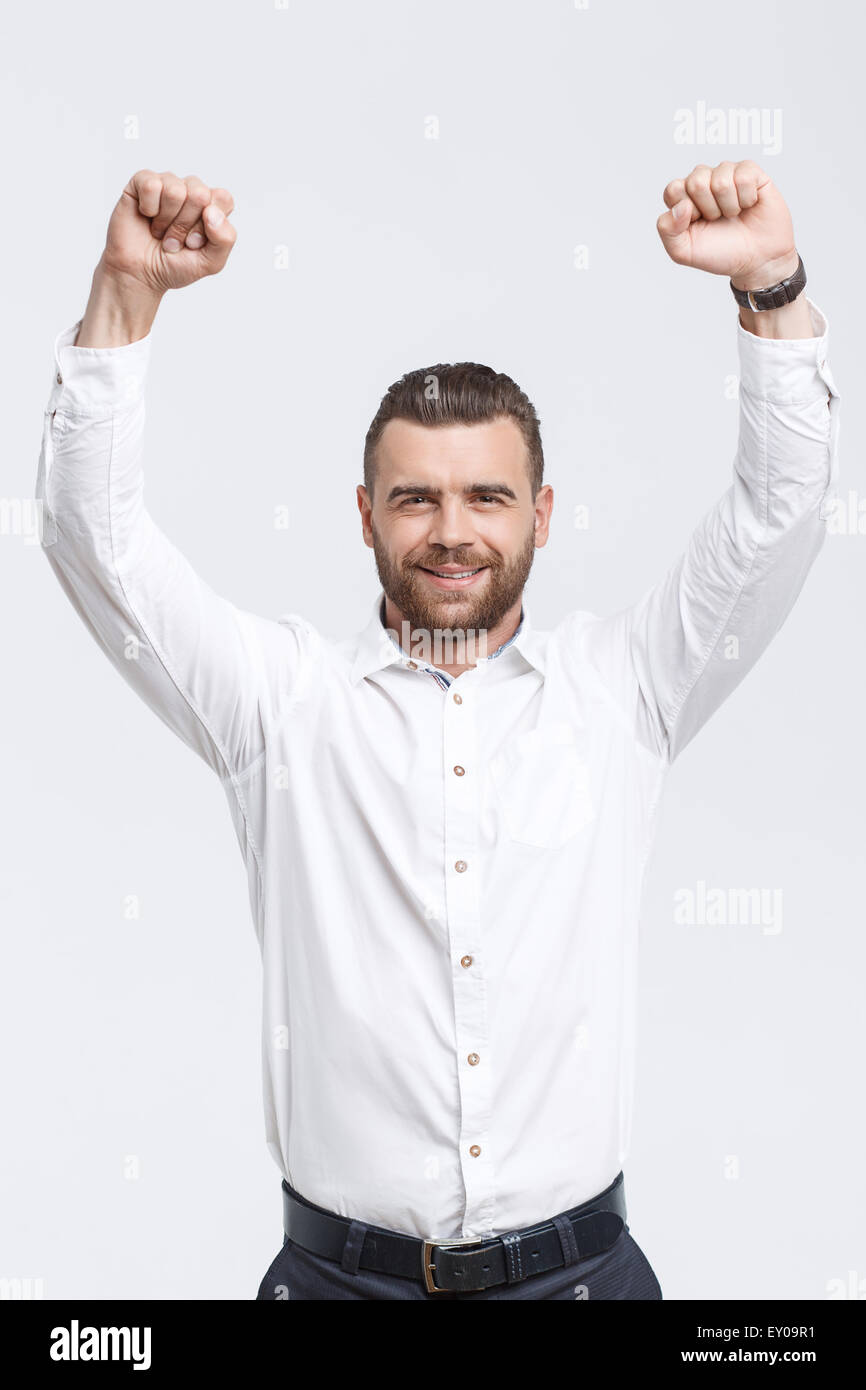 Happy handsome man cheering arms hi-res stock photography and images ...