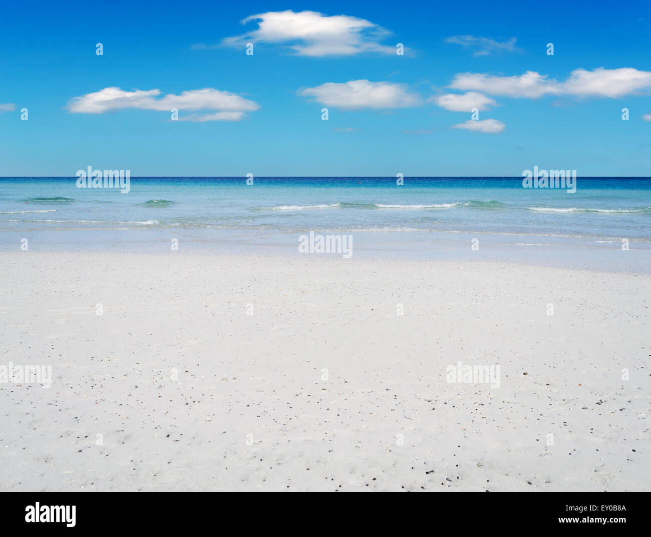 beach with white sand under a blue sky Stock Photo - Alamy