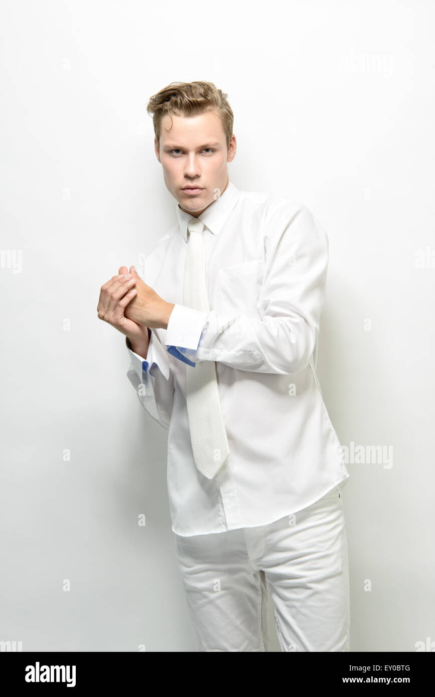 A blond, handsome man, male model, posing in an all white outfit, a futuristic  fashion concept Stock Photo - Alamy
