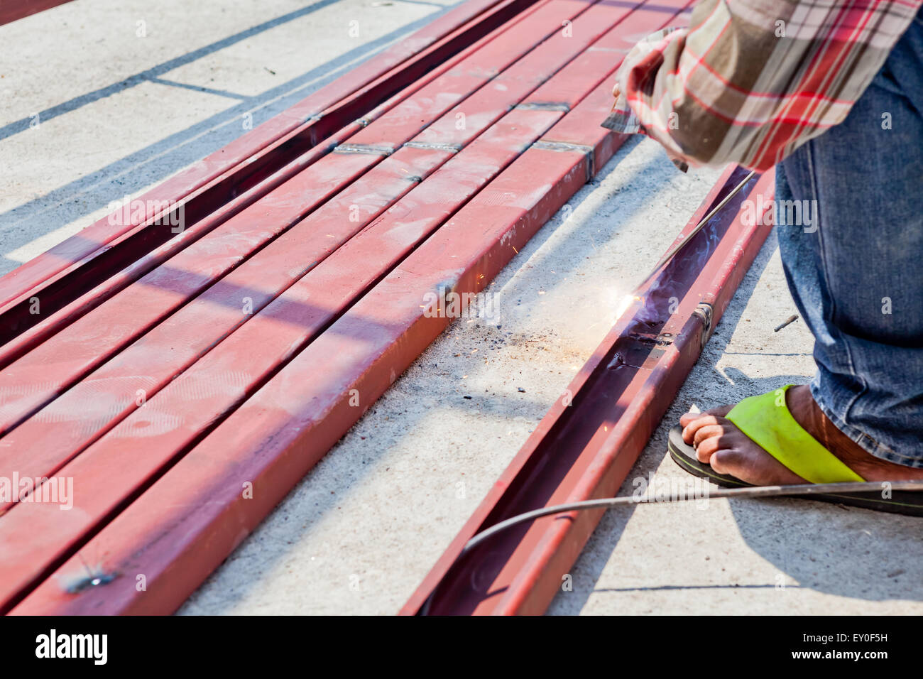 an man welding the iron bars together Stock Photo