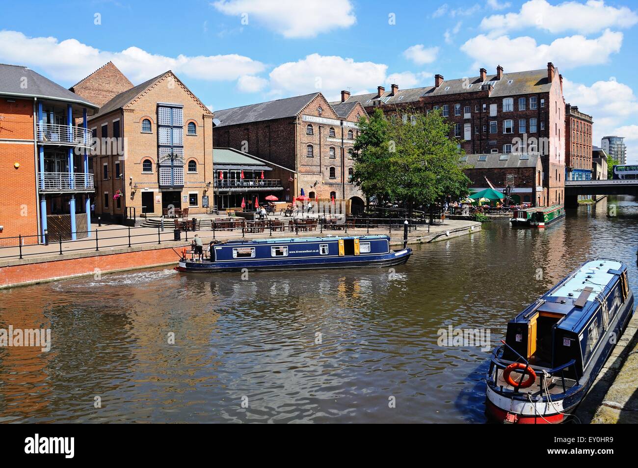 Narrowboats travelling along the Nottingham and Beeston Canal with buildings along the city wharf, Nottingham, England, UK. Stock Photo