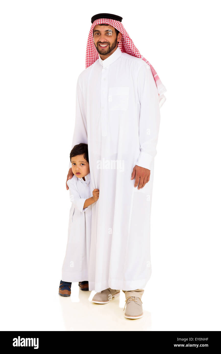 handsome Muslim man standing with his shy son Stock Photo