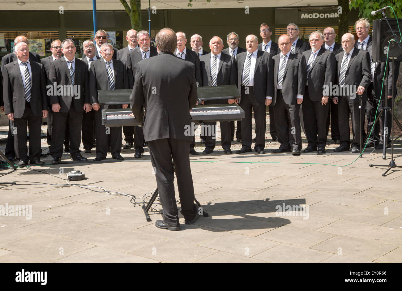 Male voice choir performing in Castle Square, Swansea, West