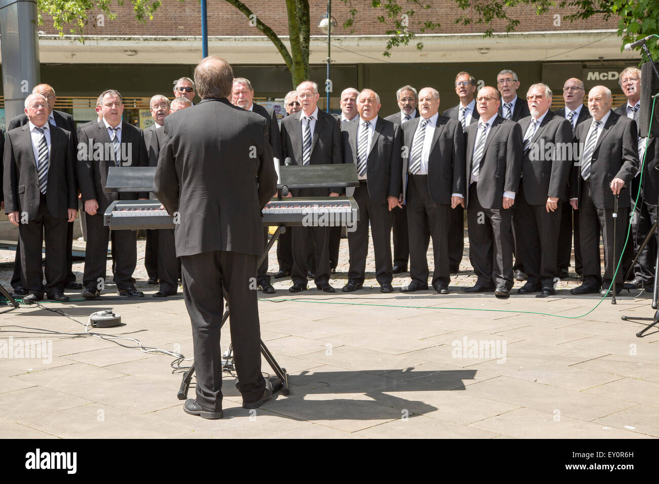 Male voice choir performing in Castle Square, Swansea, West Glamorgan, South Wales, UK Stock Photo