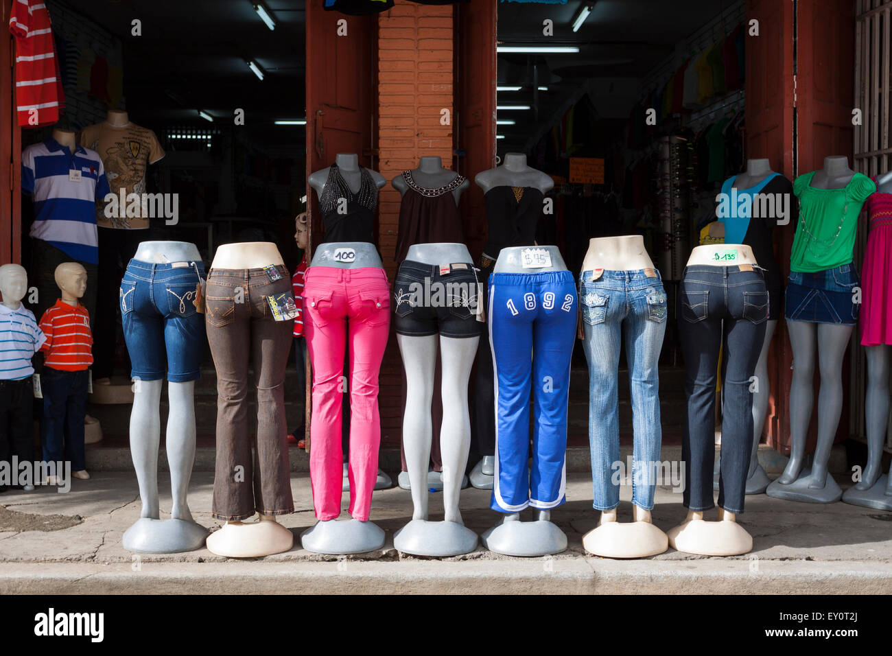Colorful jeans on mannequins in front of clothing store in León, Nicaragua Stock Photo