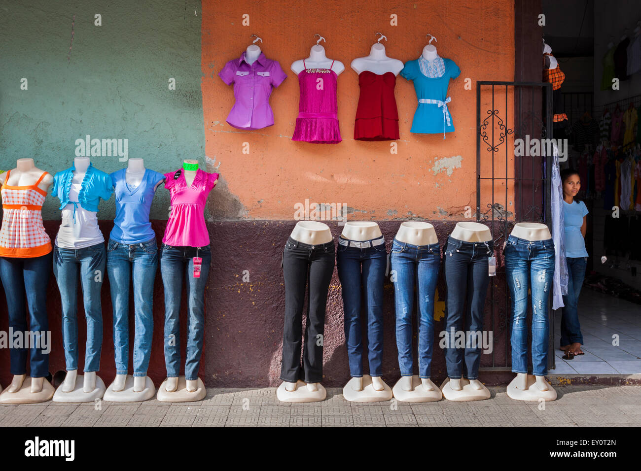 Jeans and women's clothing on mannequins and shopgirl on a store in León, Nicaragua Stock Photo