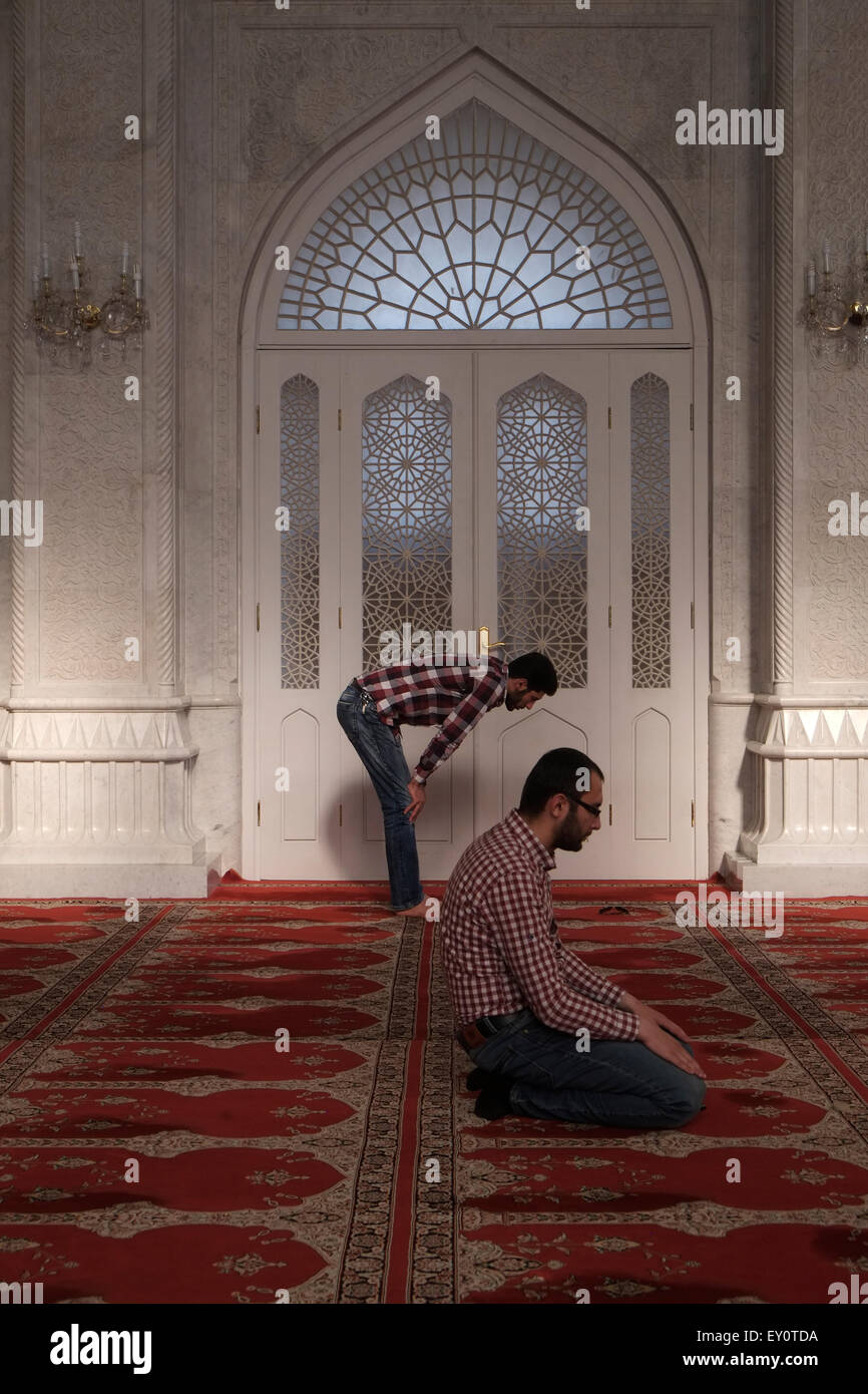 Muslim men praying inside the Bibi-Heybat Mosque locally known as 'the mosque of Fatima' in the city of Baku capital of Azerbaijan Stock Photo