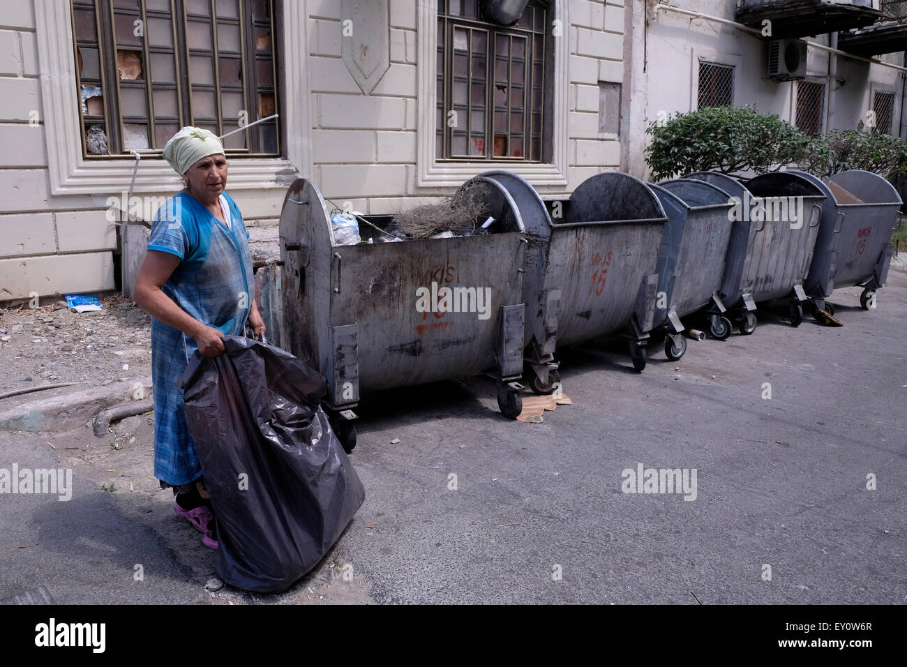 A woman collecting recyclable materials from garbage bins in the city of Baku capital of Azerbaijan Stock Photo