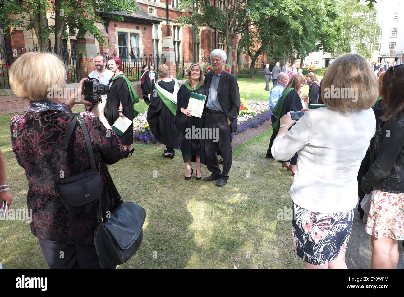 Student Graduation Day at University of Leeds graduate poses for photographs with family July 2015 UK Stock Photo