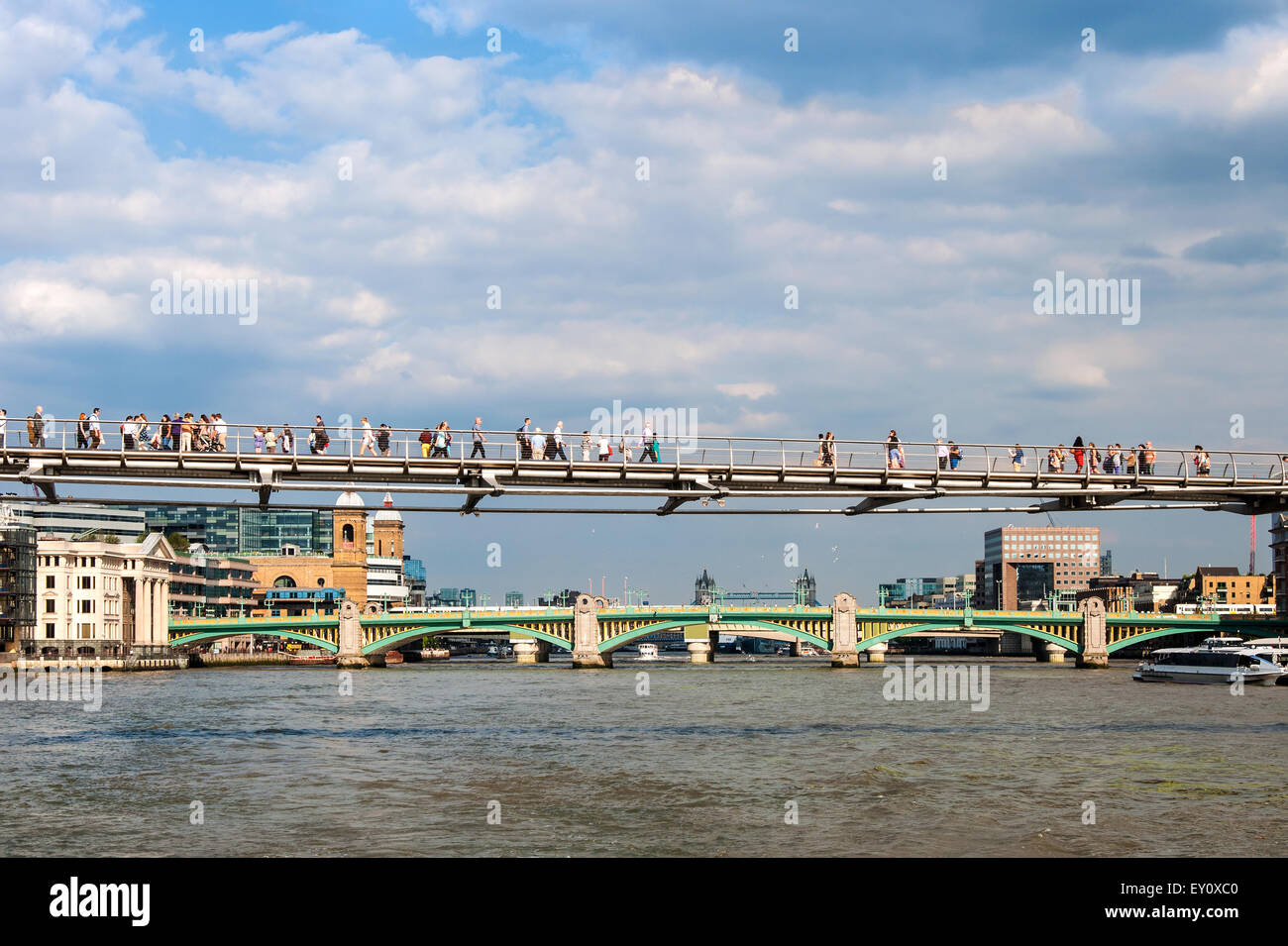 London Millennium Footbridge, nicknamed also 'Wobbly Bridge' and unrecognizable people walking over the Thames river. Below far Stock Photo