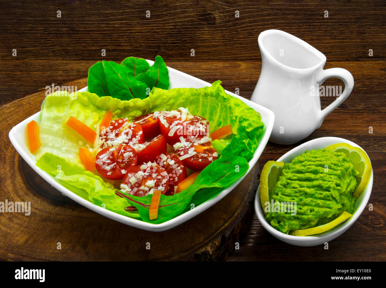 Fresh salad, avocado with lemon and green beans. Wooden background. Stock Photo