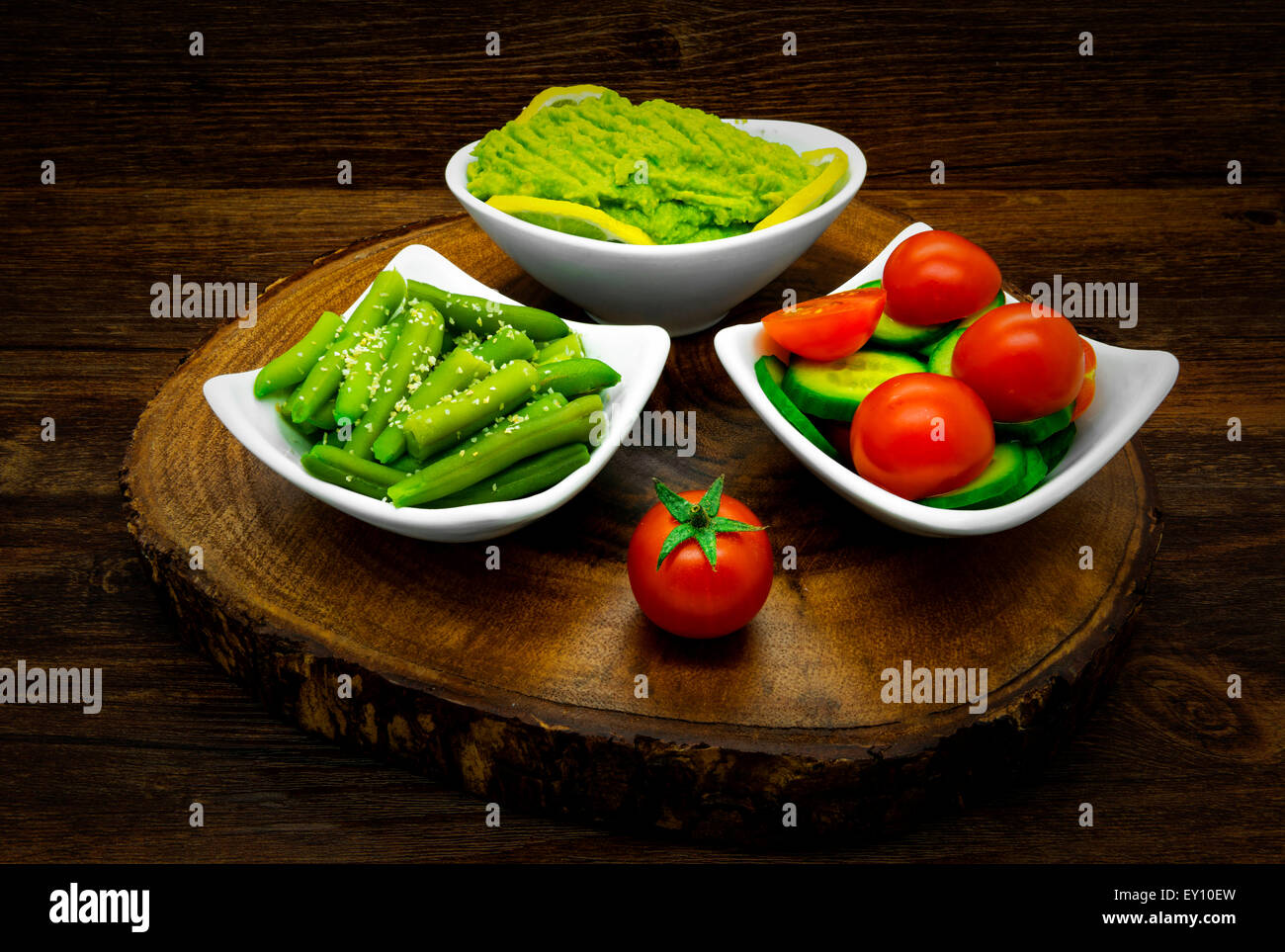 Vegetables on a dark wooden background. Salads, avocado, green beans. Stock Photo