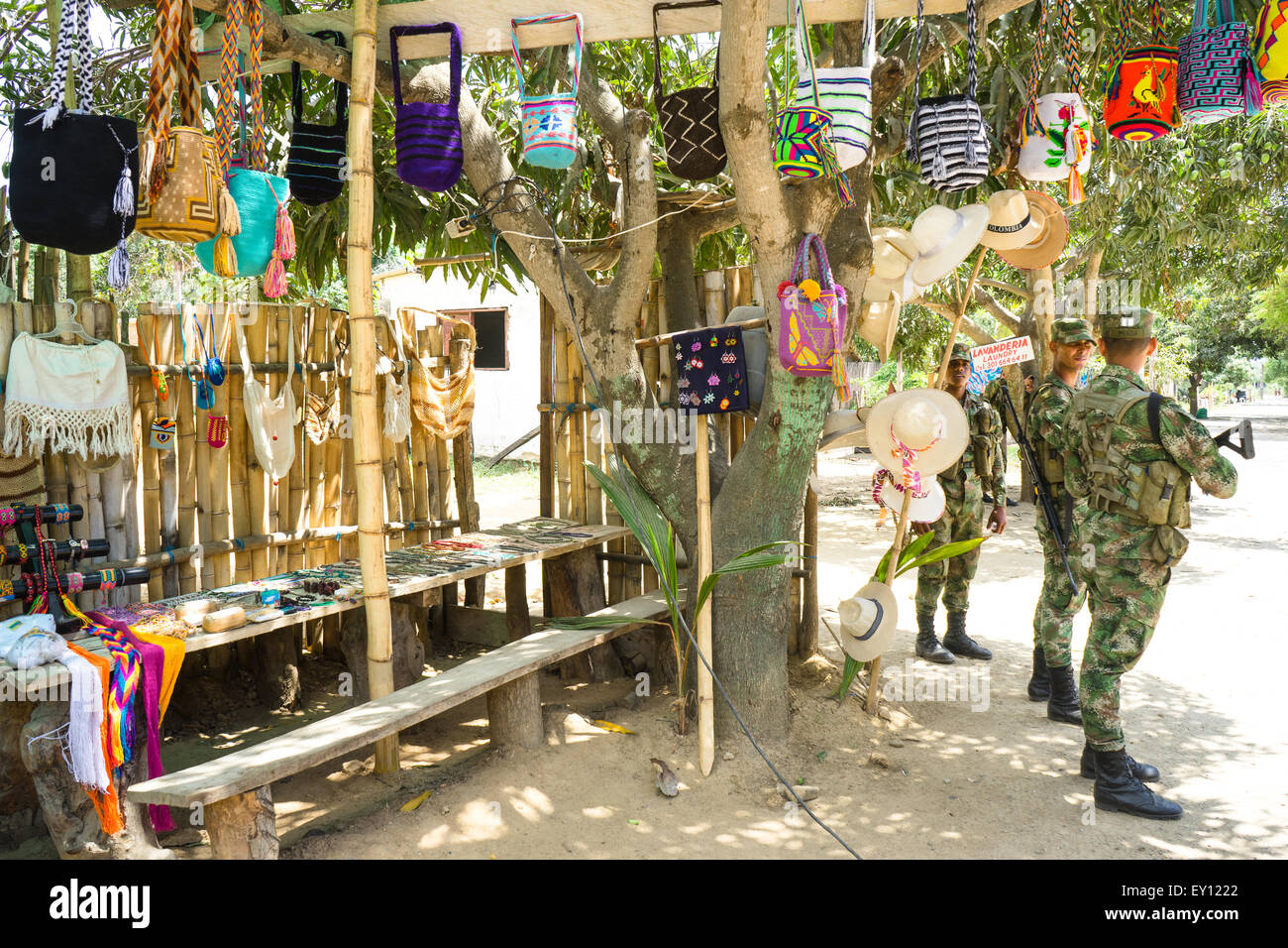 Colombian military patrolling by a handicraft shop in Palomino, La Guajira, Colombia. Stock Photo