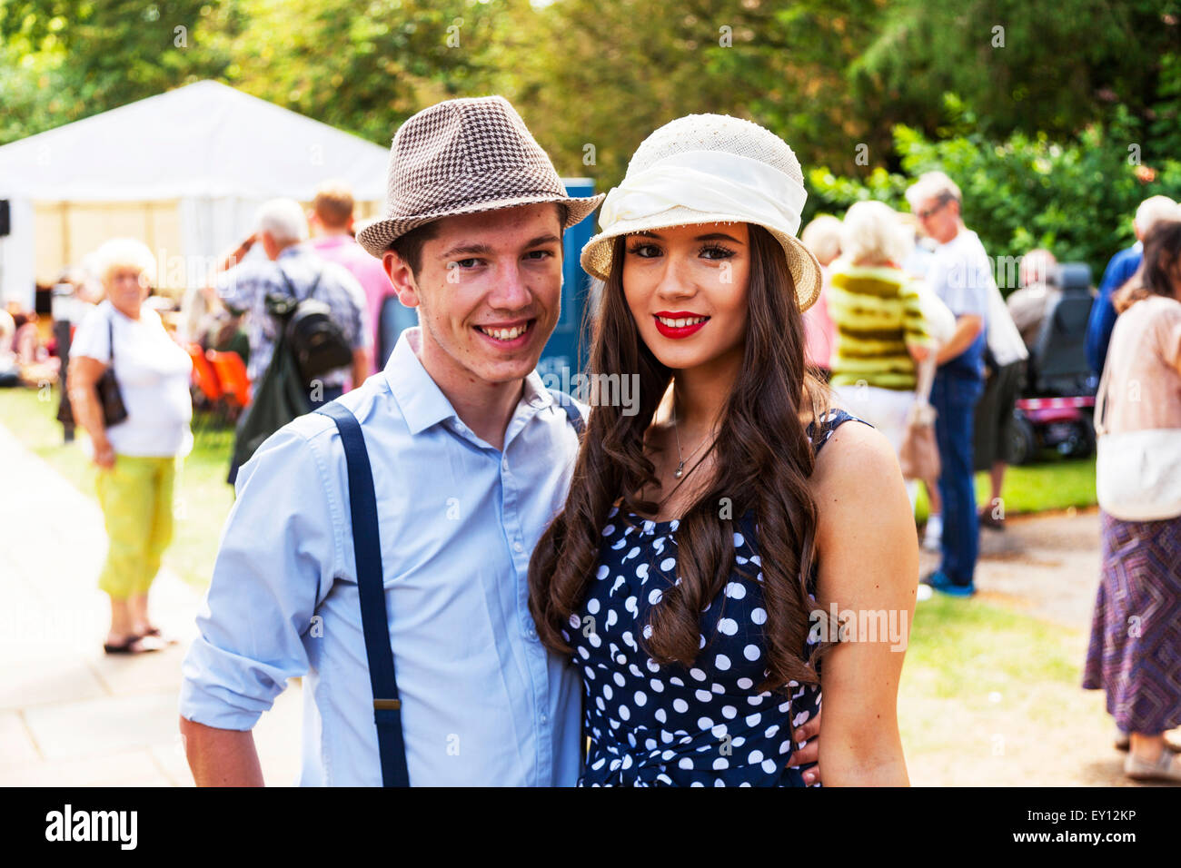 Young lovers looking cute together wearing hats braces pretty girl young woman handsome man Stock Photo