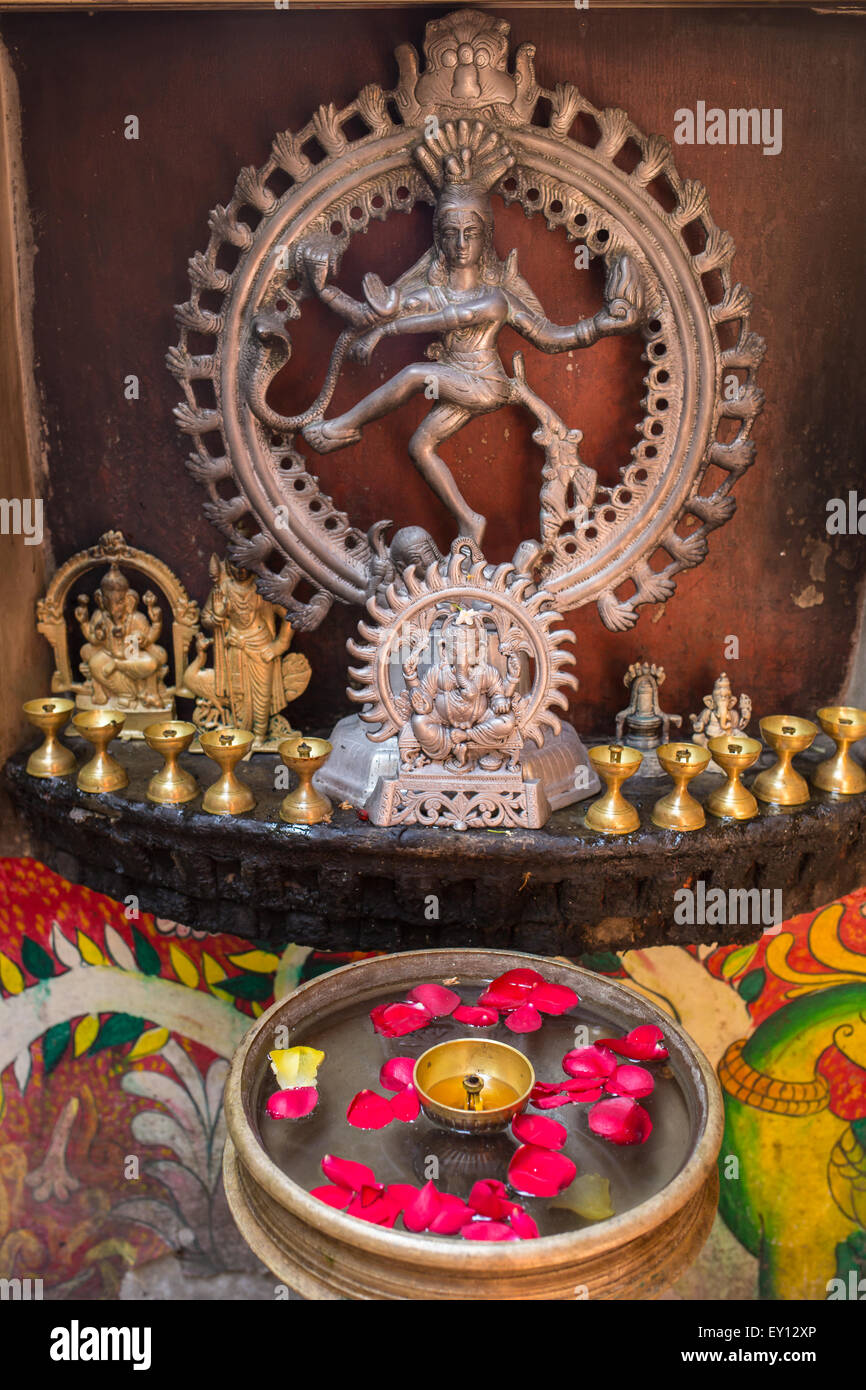 Statue of Shiva, incense and candles Stock Photo Alamy