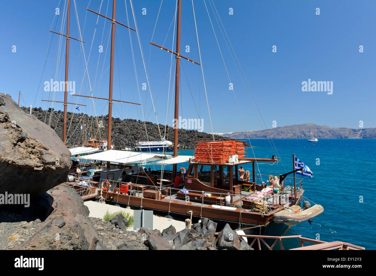 Sunbathers on a sailing boat moored near the Volcanic Island of Nea ...