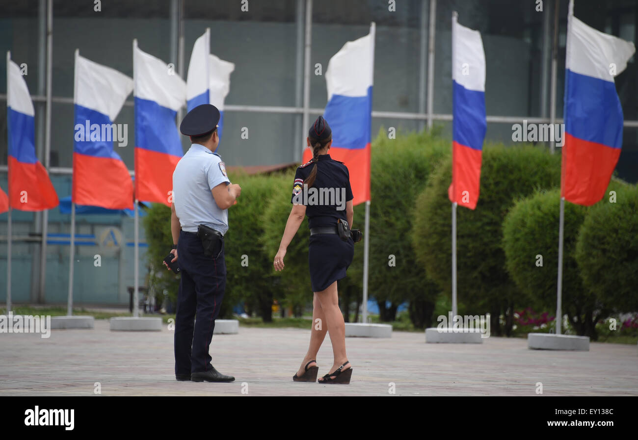 Two police officers stand in front of the airport in Volvograd, Russia in front of Russian flags 15 July 2015. The city will host games of the 2018 FIFA world cup. Photo: MARCUS BRANDT/dpa Stock Photo