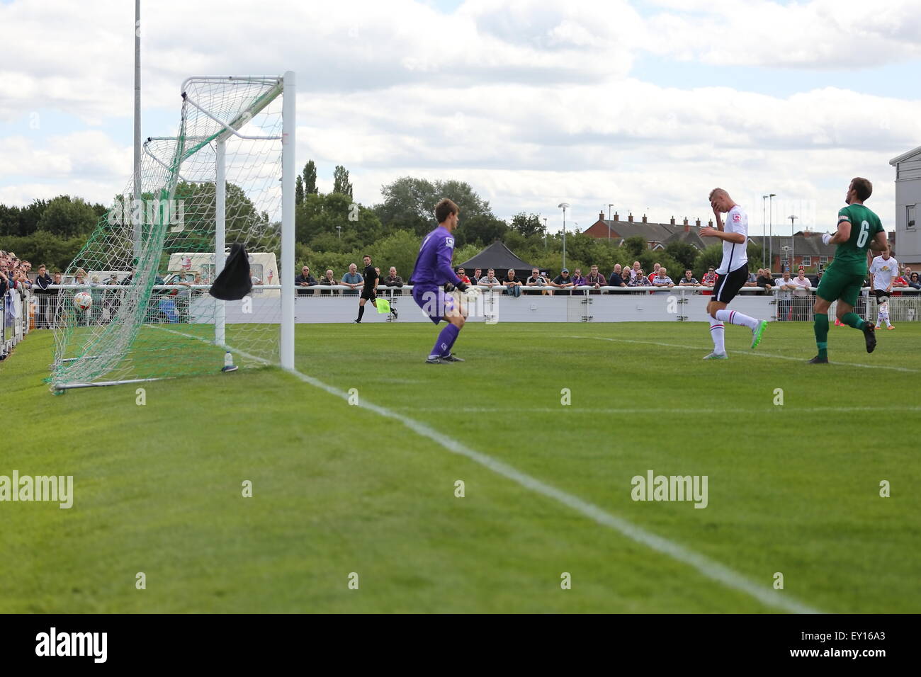 Nantwich, UK. 19th July, 2015. Crewe Alexandra's George Ray heads the ball past his own keeper to score an own goal and bring the scores level at 1-1 during the pre-season friendly match at The Weaver Stadium, Nantwich as Nantwich Town entertained Crewe Alexandra. Credit:  SJN/Alamy Live News Stock Photo