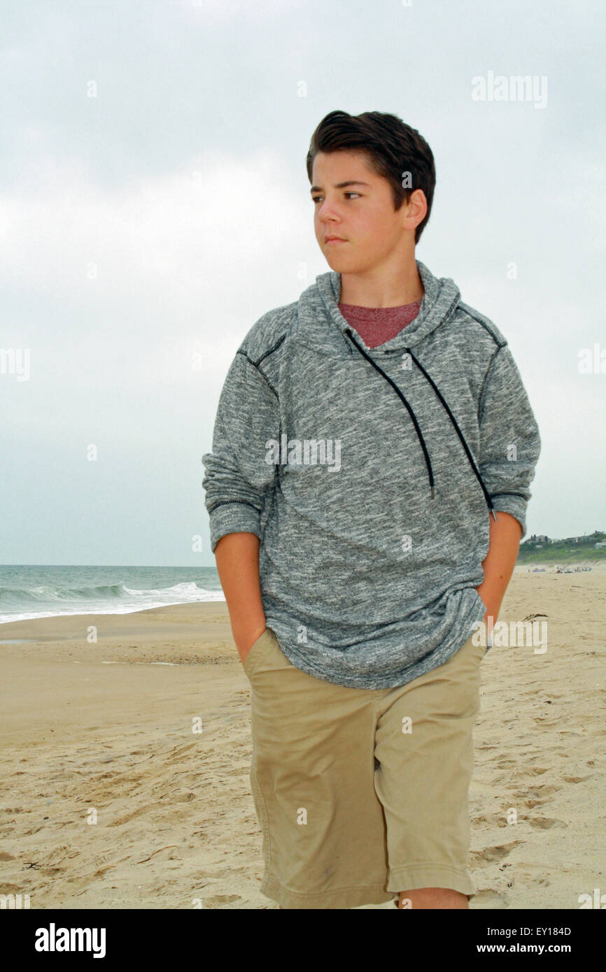 Boy Walking on Beach along Atlantic Ocean Montauk The Hamptons Long Island New York Stock Photo