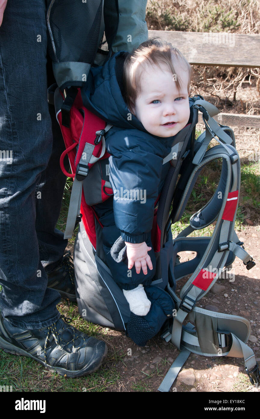 Portrait of a baby girl smiling in a baby carrier Stock Photo