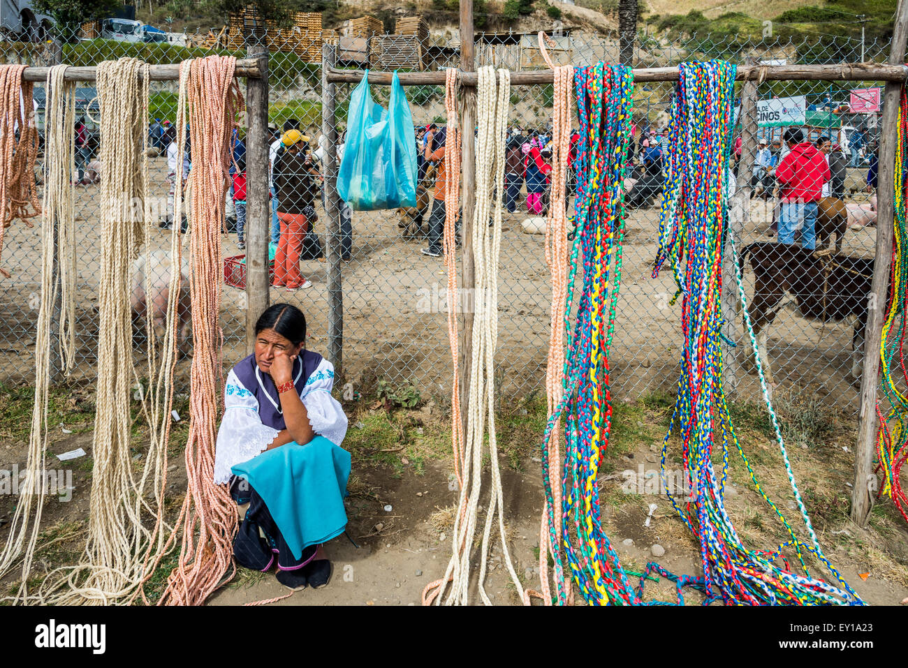 A native woman selling her hand-made ropes at local market. Otavalo, Ecuador. Stock Photo