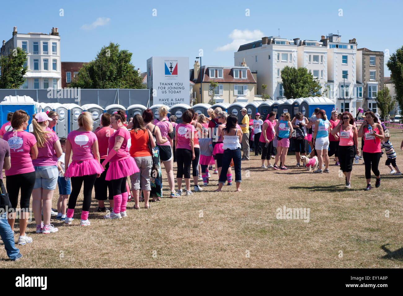 competitors in the 2015 race for life in aid of cancer research uk queue for the portable toilets in southsea england uk Stock Photo