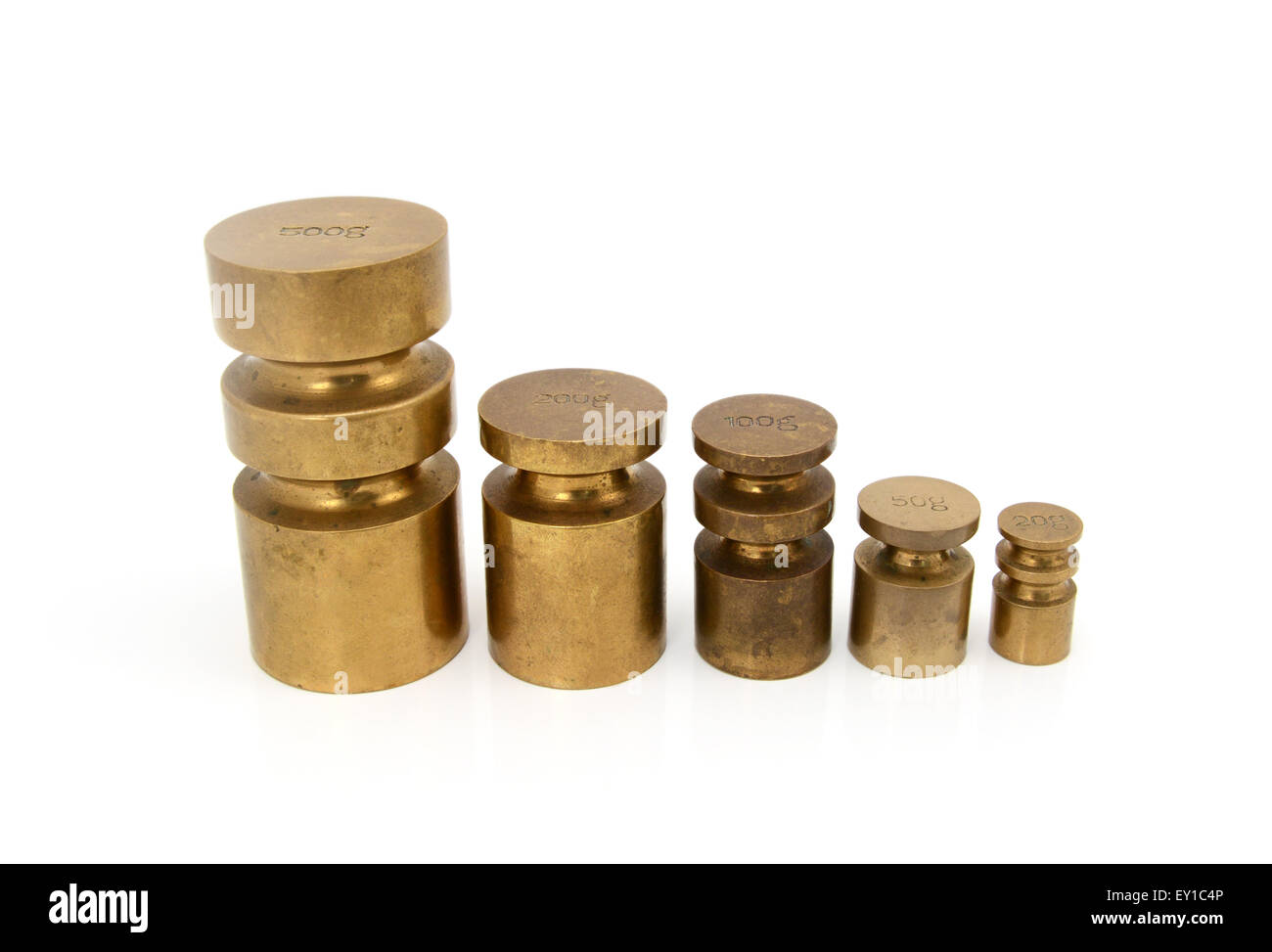 Set of brass metric weights in grams - 500g, 200g, 100g, 50g and 20g metal cylinders Stock Photo