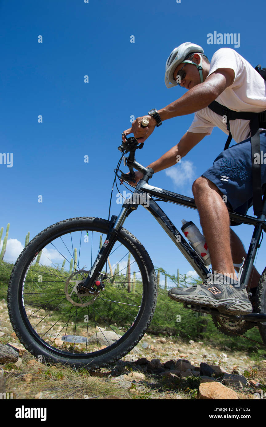 Youth of Aruba hill climbing the rocky part of Aruba Stock Photo