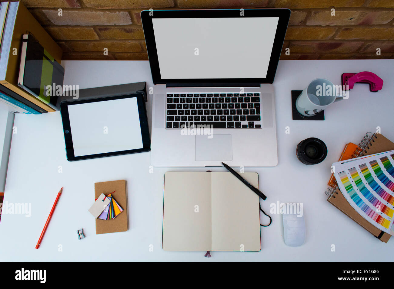 Creative Home Office space with graphic designers desk with laptop against  a brick wall Stock Photo - Alamy