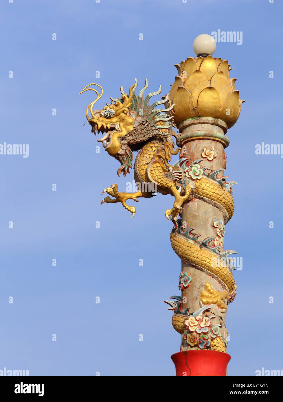 Golden dragon statue on pole with sky Stock Photo