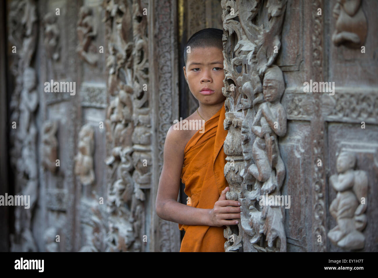 Novice monk in monastery doorway, Mandalay, Myanmar Stock Photo