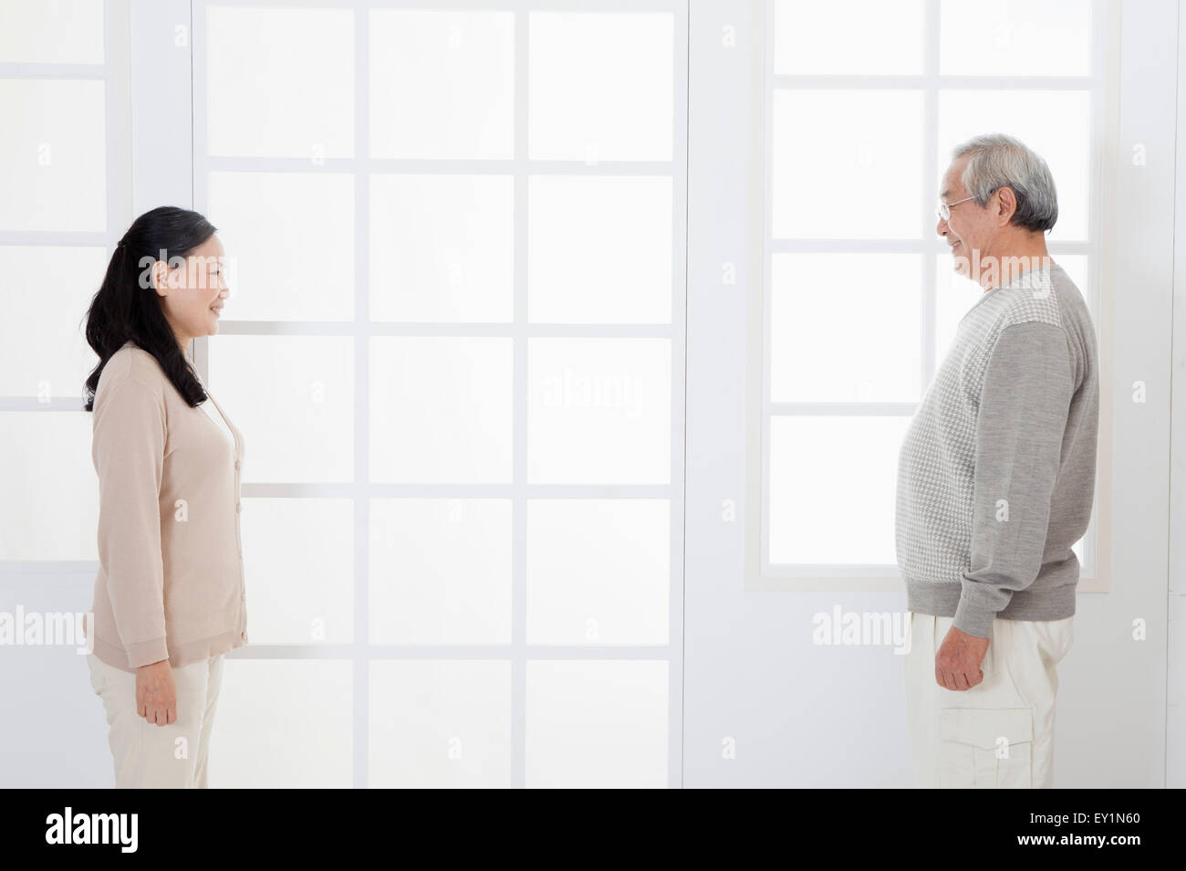 Senior couple standing and looking at each other, Stock Photo