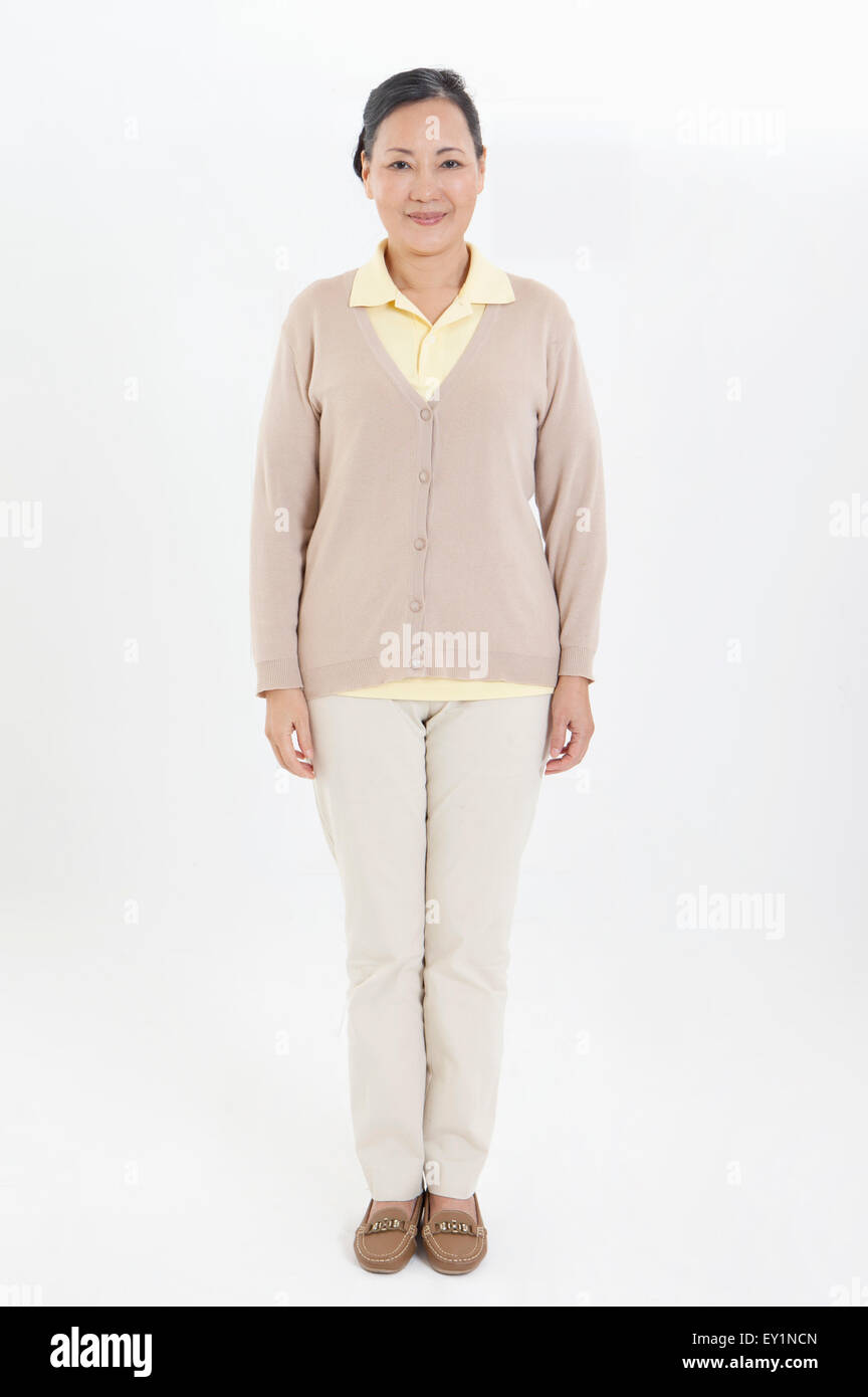 Senior woman standing and smiling at the camera Stock Photo - Alamy