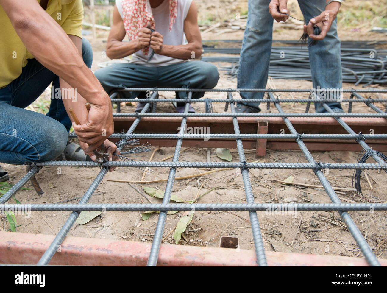 the workers are  preparing steel poles for building house Stock Photo