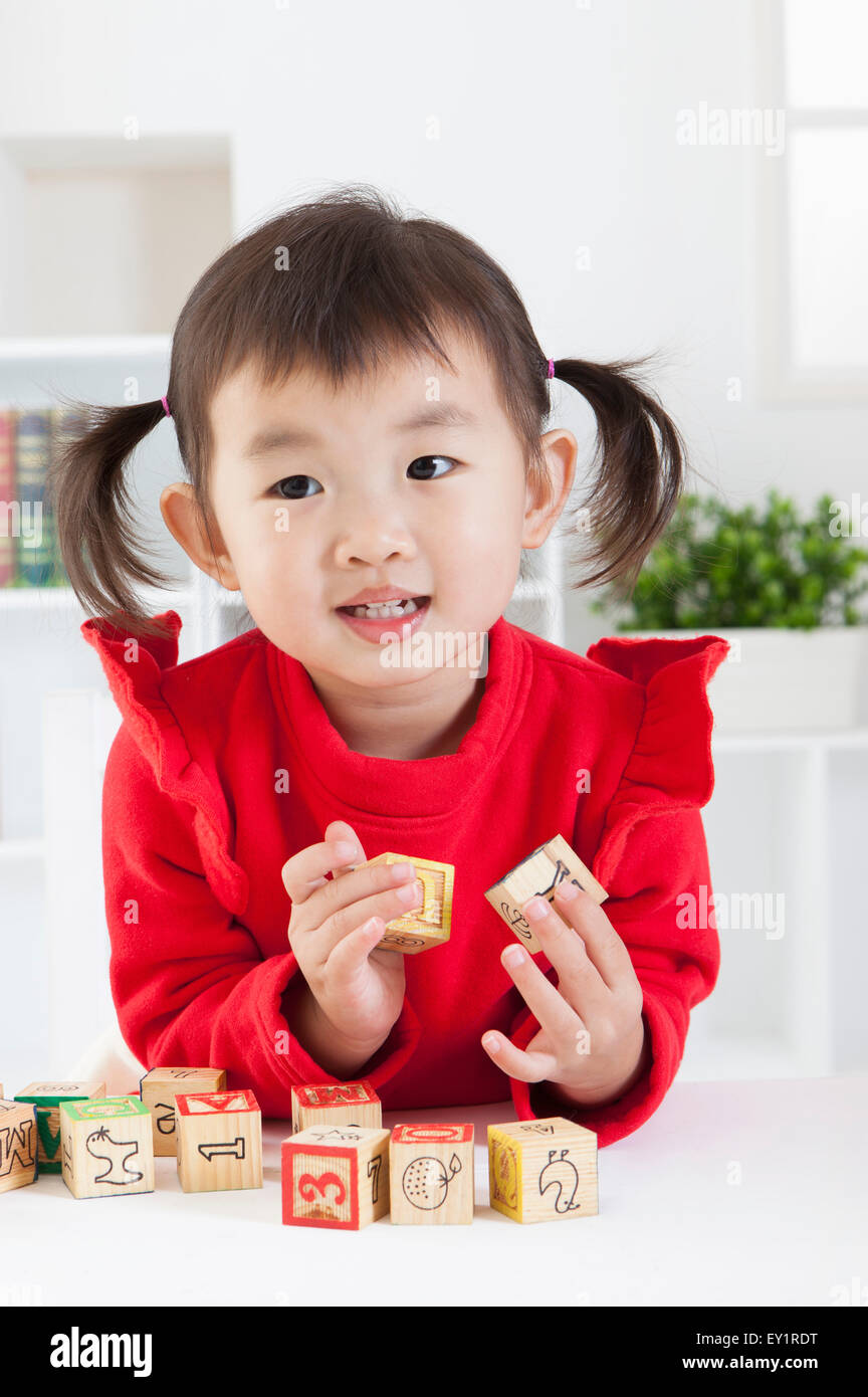 Little girl playing puzzles with smile Stock Photo Alamy