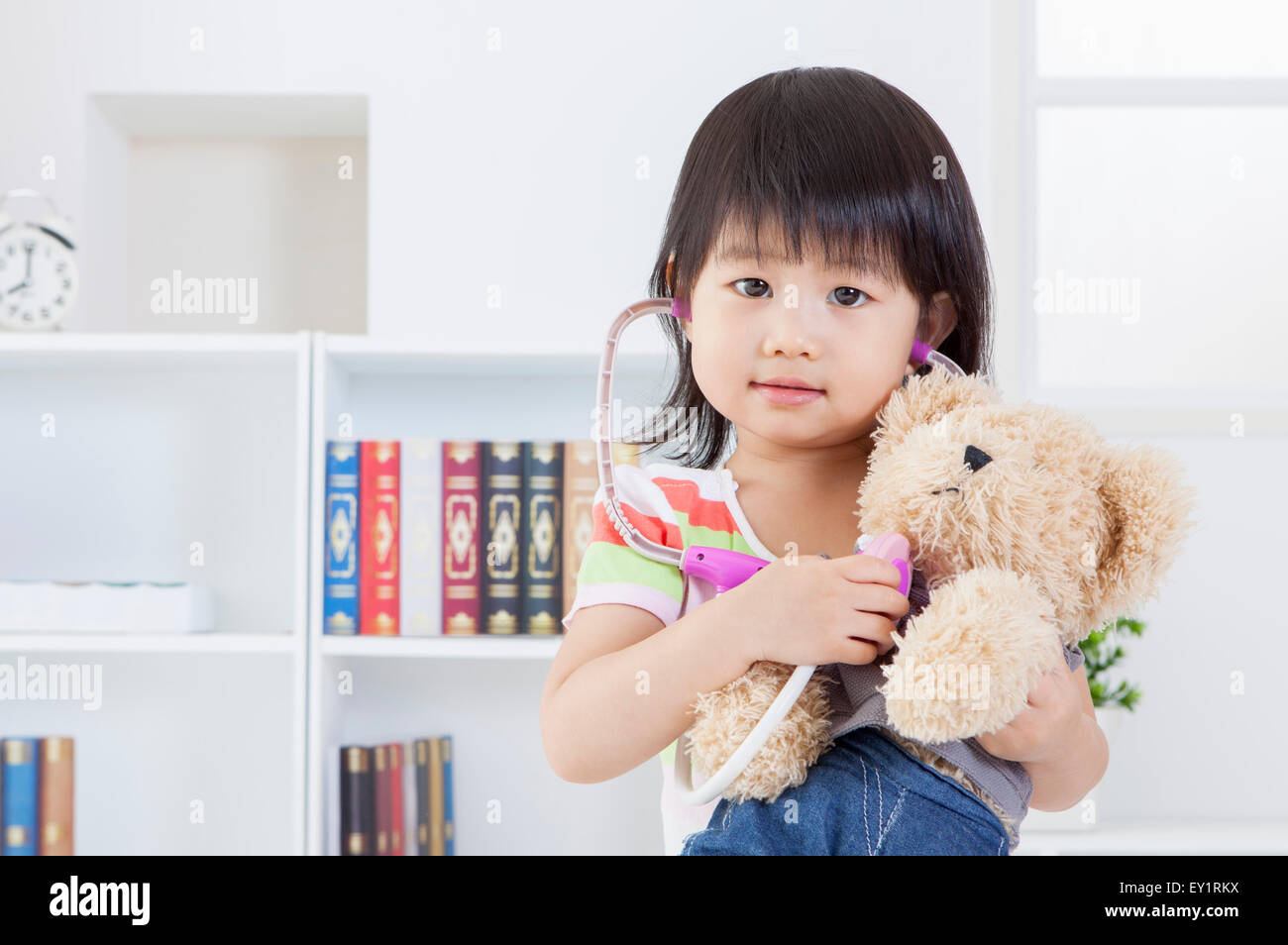 Girl holding teddy bear hi-res stock photography and images - Alamy