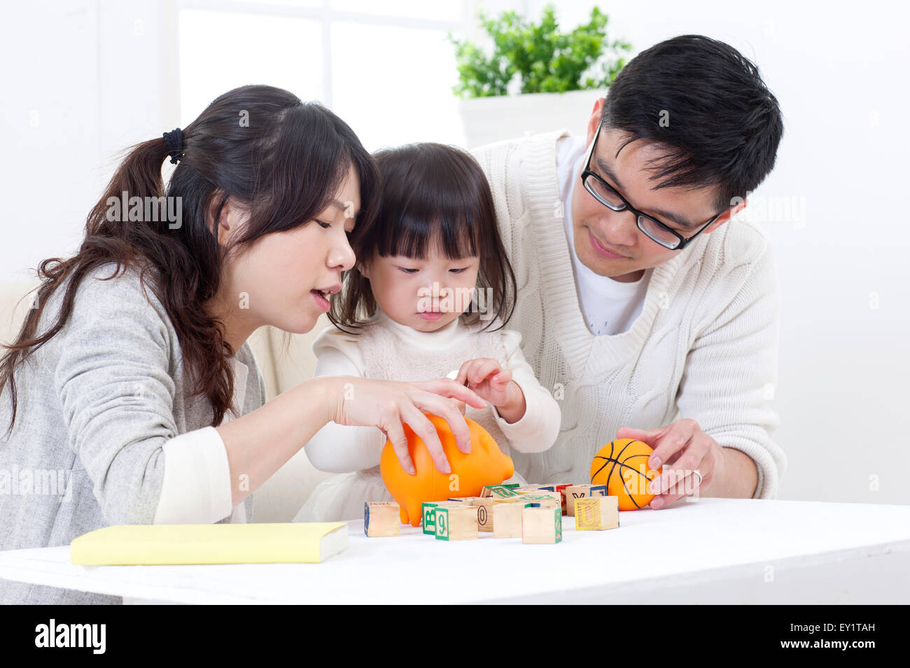 Family with one child playing together, Stock Photo