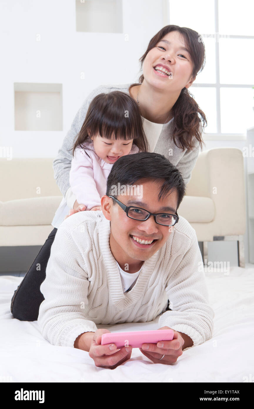 Family with one child playing and smiling together, Stock Photo