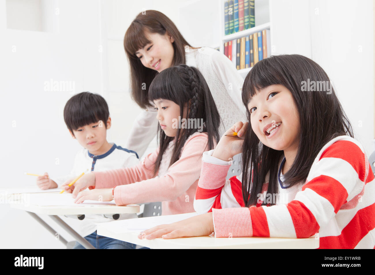 Schoolgirl studying in the classroom and looking away with smile Stock ...