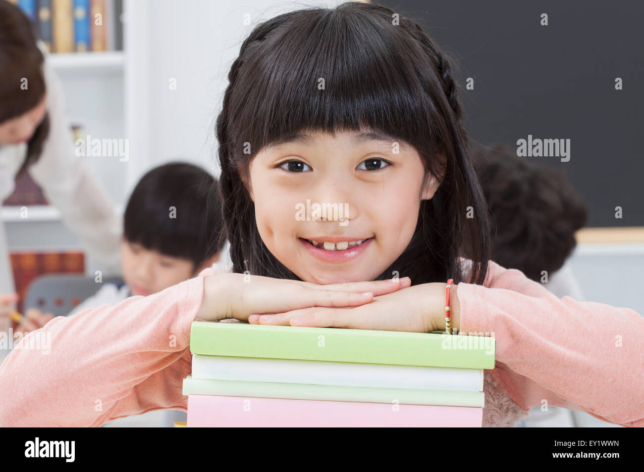 Girl sitting in the classroom and smiling at the camera Stock Photo - Alamy