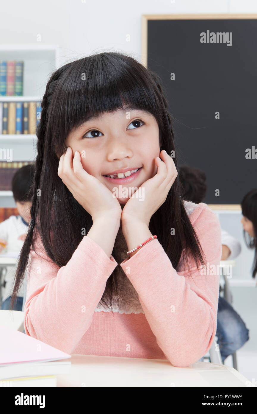 Girl sitting in the classroom and looking up with smile Stock Photo - Alamy