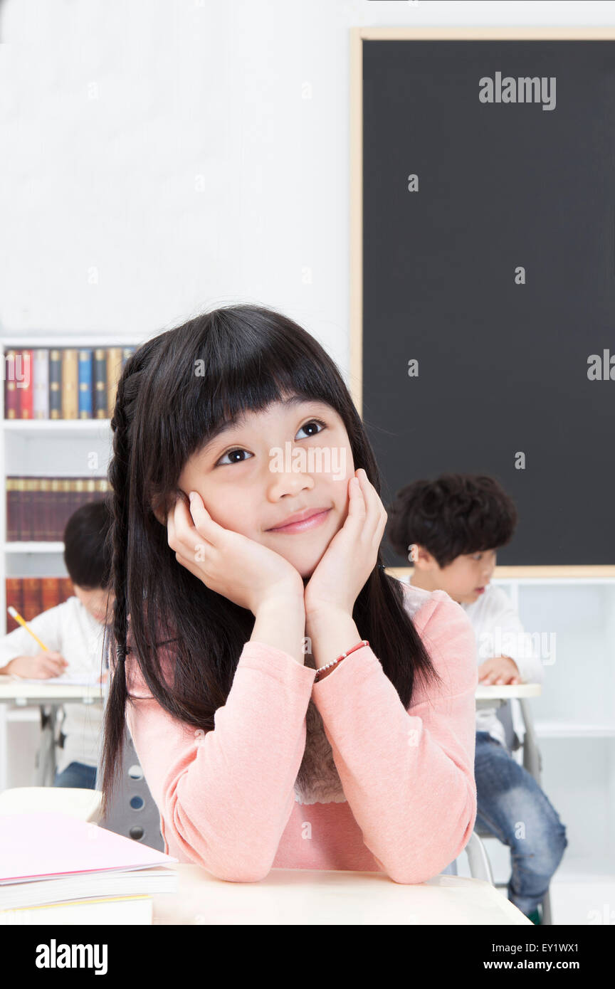Girl sitting in the classroom and looking up with smile Stock Photo - Alamy