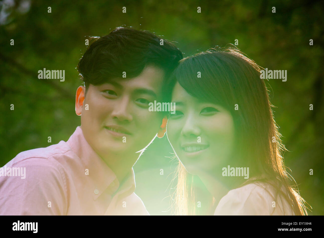 Young man and pregnant woman smiling at the camera together Stock Photo ...