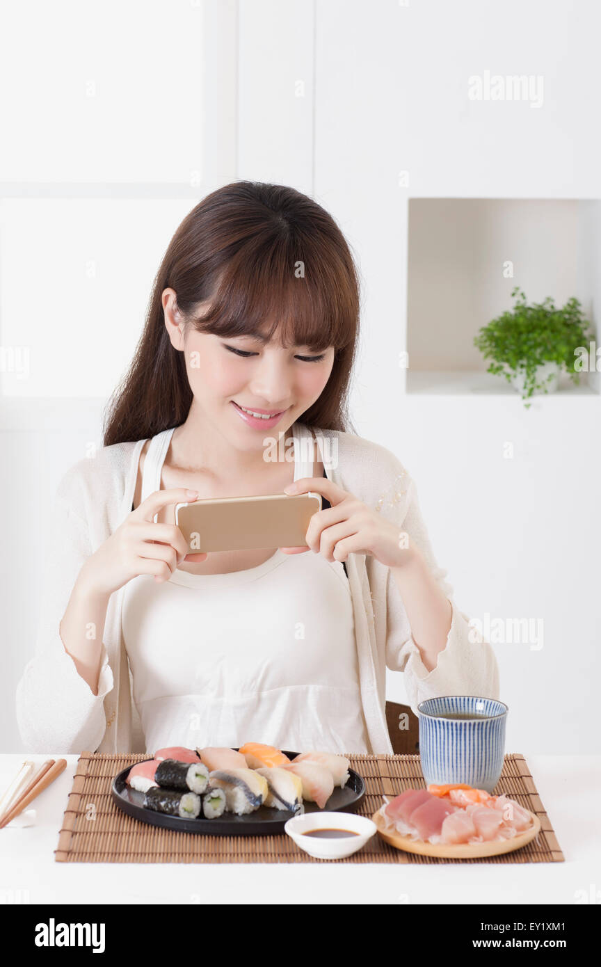 Young woman looking at mobile phone with smile, Stock Photo
