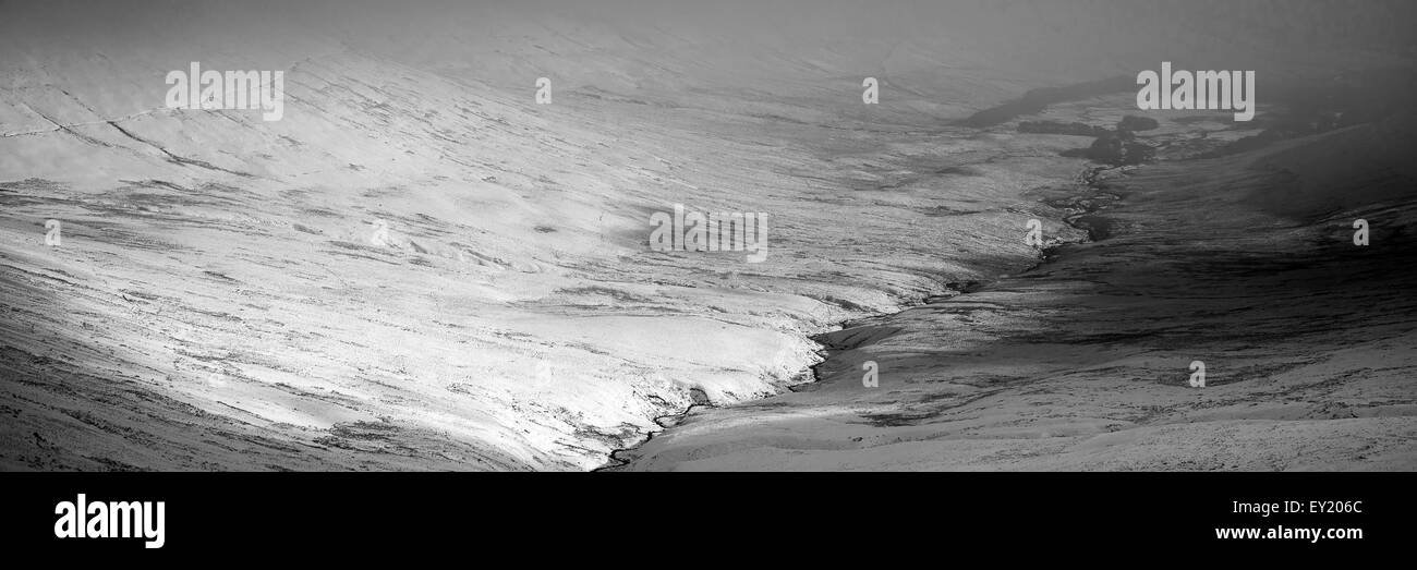 Moody dramatic low cloud Winter landscape in mountains in black and white Stock Photo