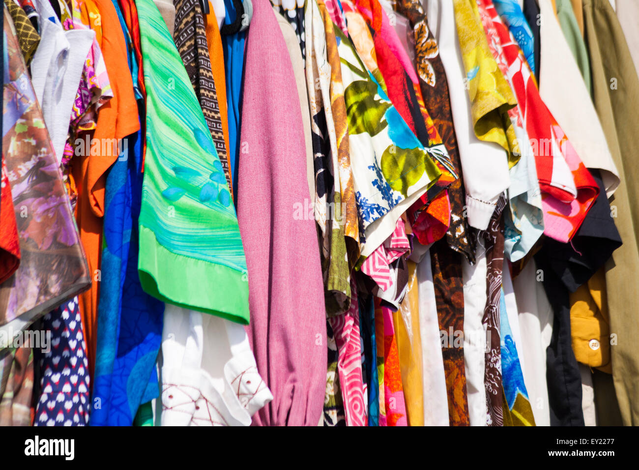 Material of colourful vintage retro shirts and blouses for sale at Poole Vintage event in July Stock Photo
