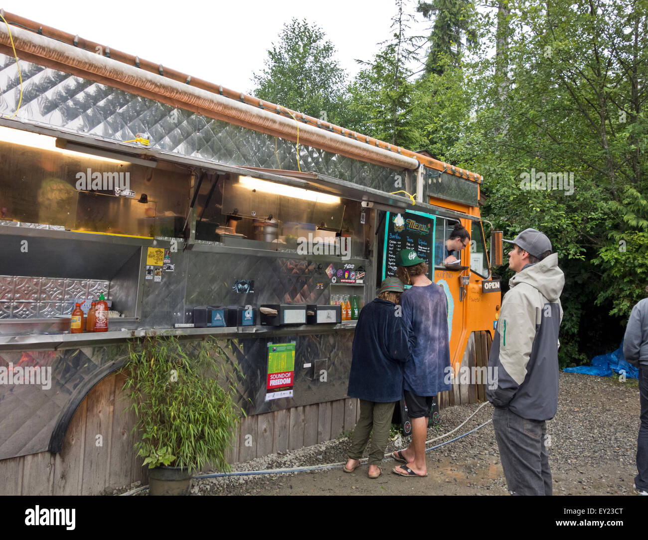 Customers wait for their food orders from Tacofino food truck, a highly rated takeout restaurant in Tofino, BC. Stock Photo