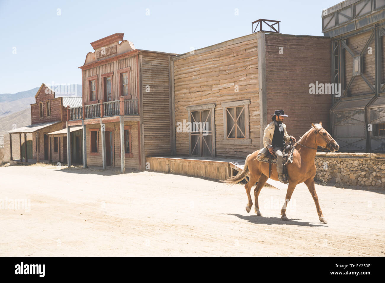 Cowboy riding horse on wild west film set, Fort Bravo, Tabernas, Almeria, Spain Stock Photo