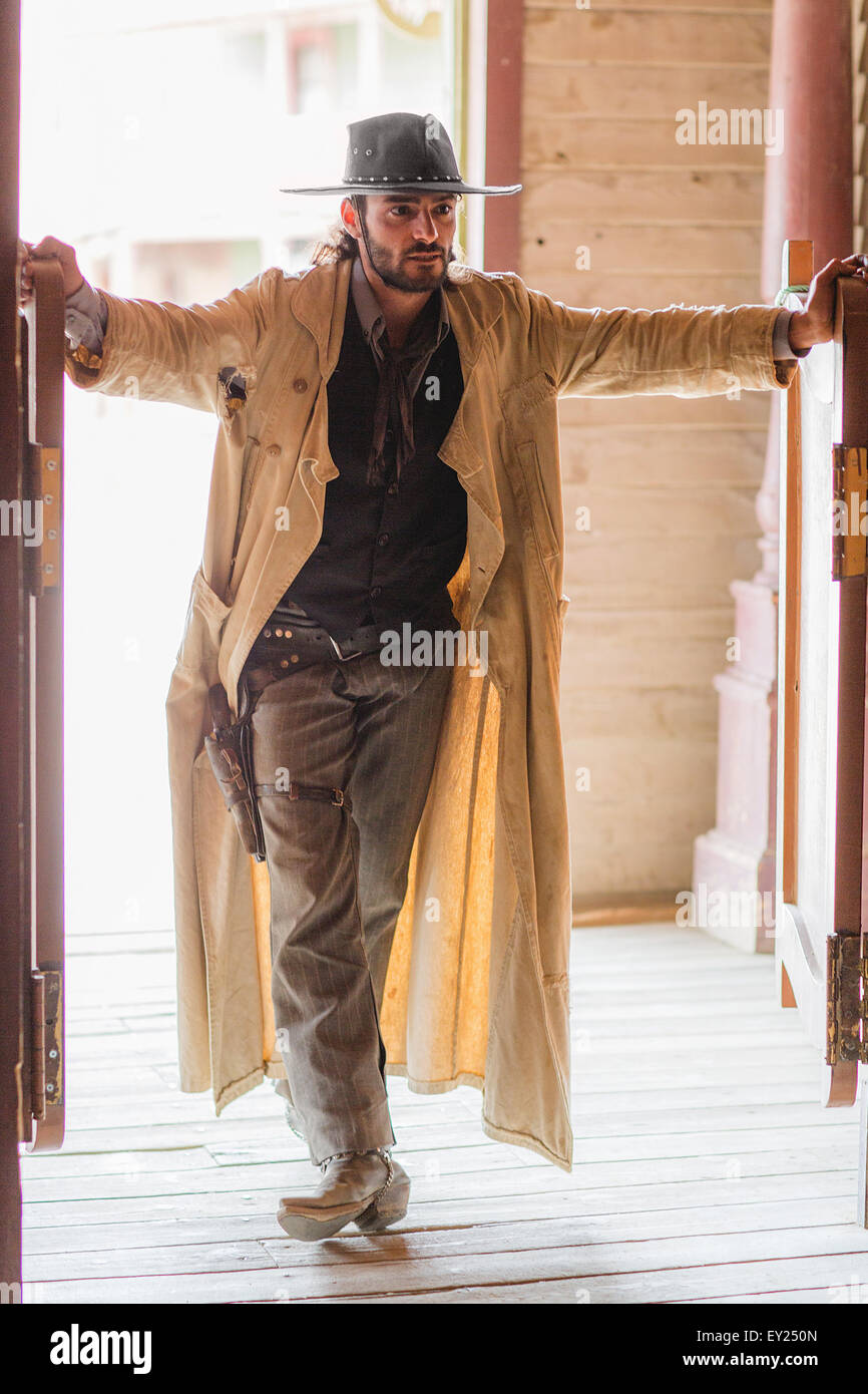 Cowboy standing in saloon doorway on wild west film set, Fort Bravo, Tabernas, Almeria, Spain Stock Photo