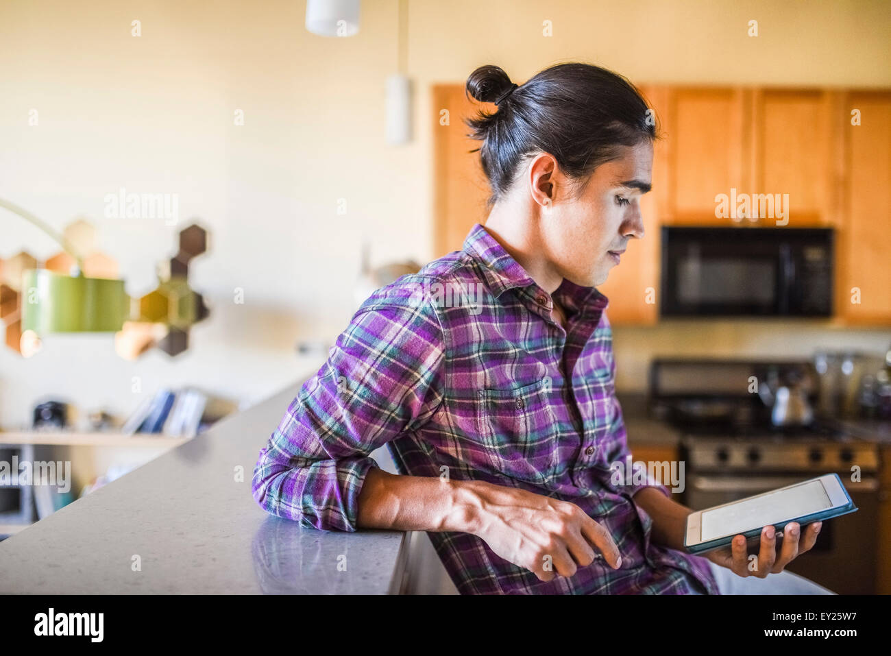 Young Man Using Tablet Man tablet dark hi-res stock photography and images - Alamy